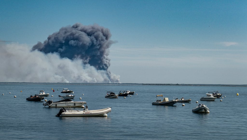 Smoke from wildfires spreading on the Cap Ferret peninsula is seen from the Arcachon Bay in southwestern France on Friday. Photo: EPA Smoke from wildfires spreading on the Cap Ferret peninsula is seen from the Arcachon Bay in southwestern France on Friday. Photo: EPA