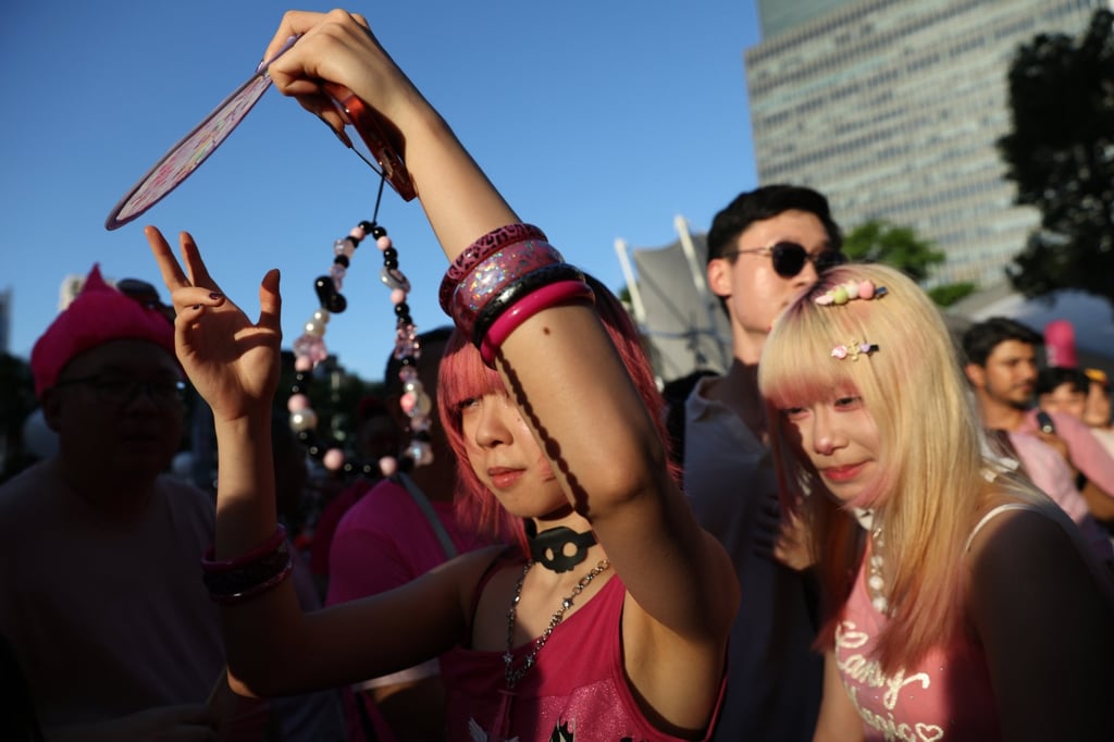 Young attendees shield themselves from the sun at last month’s Pink Dot SG pride event in Singapore. Photo: EPA Young attendees shield themselves from the sun at last month’s Pink Dot SG pride event in Singapore. Photo: EPA