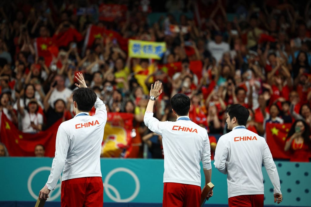 China’s men Ma Long, Wang Chuqin and Fan Zhendong wave to fans after winning team gold at the Paris Olympics. Photo: Reuters