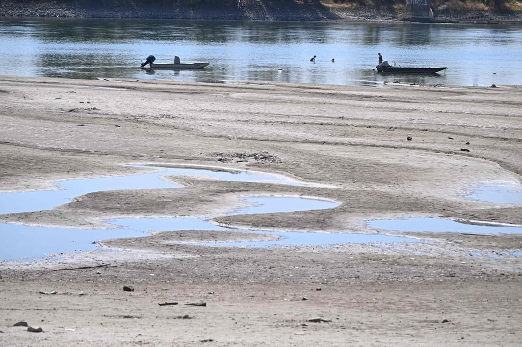 The drying-up Danube riverbed is pictured on Friday near Hungary’s Paks power plant. The river has fallen to record low levels, creating a critical operational challenge for the facility, which needs water to cool its reactors. Photo: AFP