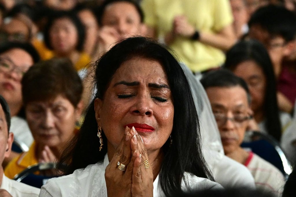 Catholic faithful attend a holy mass being led by Pope Francis at the National Stadium in Singapore in September 2024. Photo: AFP