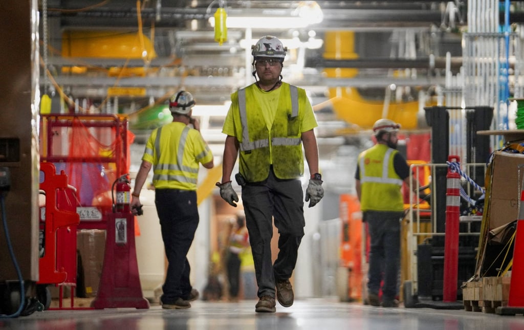Workers walk inside an AI data centre under construction in the US. Photo: Reuters Workers walk inside an AI data centre under construction in the US. Photo: Reuters