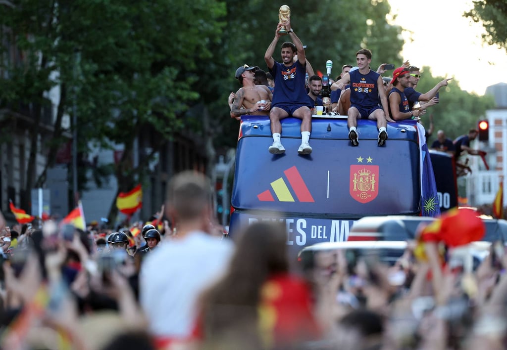 Spain’s midfielder Rodri holds the World Cup trophy on board an open-top bus during a parade through the streets of Madrid. Photo: AFP Spain’s midfielder Rodri holds the World Cup trophy on board an open-top bus during a parade through the streets of Madrid. Photo: AFP