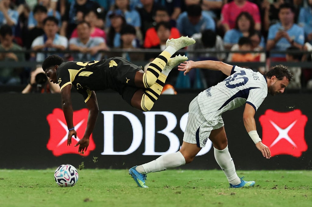 Young winger Ryan McAidoo is sent flying by Carlos Augusto. Photo: Reuters Young winger Ryan McAidoo is sent flying by Carlos Augusto. Photo: Reuters