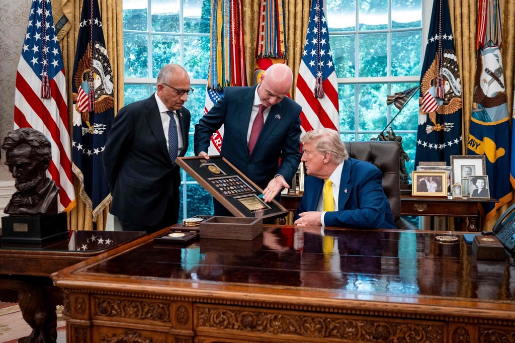 Carlos Cordeiro (left) looks on as Fifa President Gianni Infantino presents US President Donald Trump with a gift in the Oval Office. Photo: AFP Carlos Cordeiro (left) looks on as Fifa President Gianni Infantino presents US President Donald Trump with a gift in the Oval Office. Photo: AFP