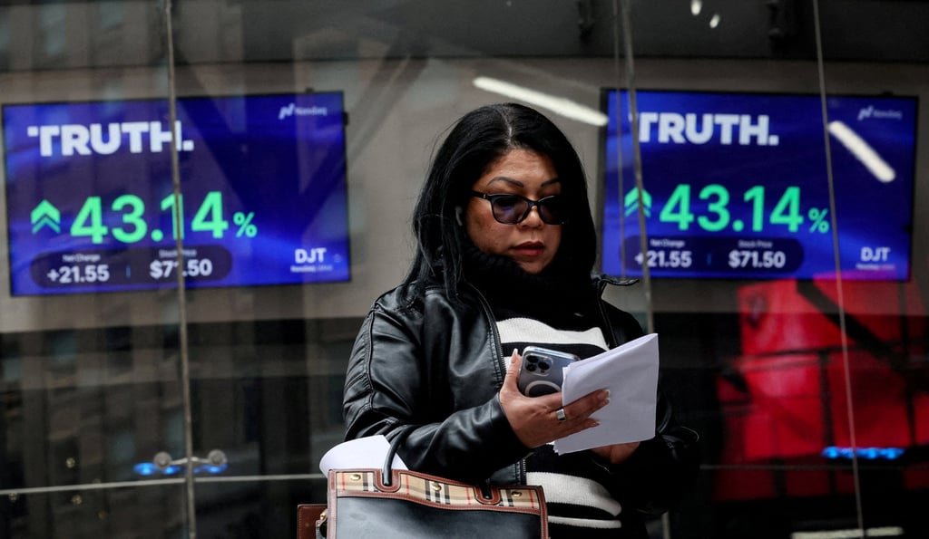 A woman looks at her phone in front of screens displaying trading information about shares of Truth Social and Trump Media & Technology Group outside the Nasdaq Market site in New York on March 26, 2024. Photo: Reuters A woman looks at her phone in front of screens displaying trading information about shares of Truth Social and Trump Media & Technology Group outside the Nasdaq Market site in New York on March 26, 2024. Photo: Reuters