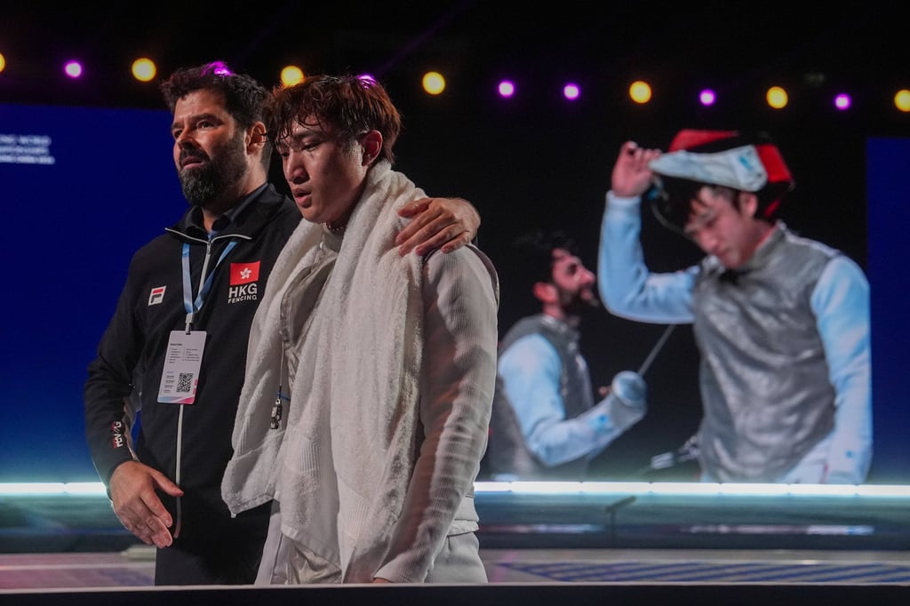Head coach Greg Koenig (left) comforts Ryan Choi after the Hongkonger lost the decisive bout to Italy’s Guillaume Bianchi in the men’s foil team final. Photo: Elson Li Head coach Greg Koenig (left) comforts Ryan Choi after the Hongkonger lost the decisive bout to Italy’s Guillaume Bianchi in the men’s foil team final. Photo: Elson Li