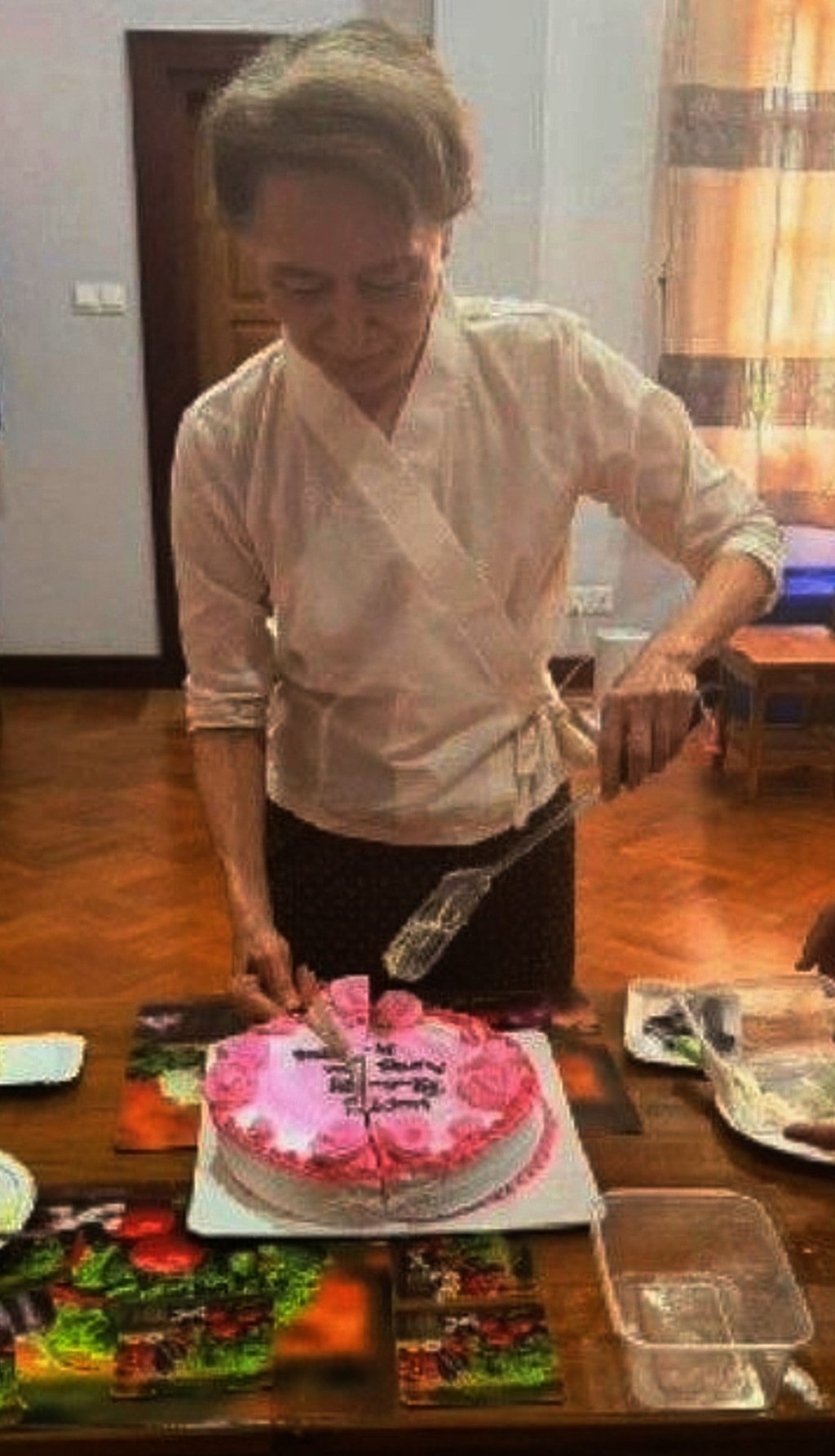 Myanmar ousted leader Aung San Suu Kyi cuts a birthday cake during her meeting with Arnaud de Baecque on Monday. Photo: Myanmar President Office/AP Myanmar ousted leader Aung San Suu Kyi cuts a birthday cake during her meeting with Arnaud de Baecque on Monday. Photo: Myanmar President Office/AP