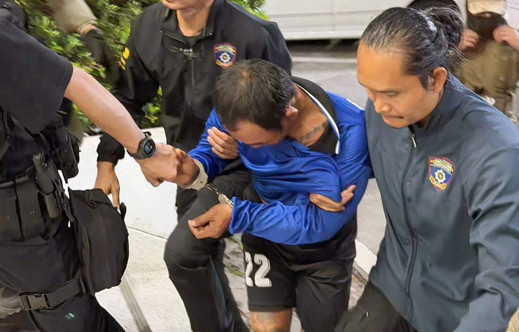 Thana Kerdthong is brought in for investigation at the Huayyai police station in Chonburi province on Friday. Photo: Royal Thai Police/EPA Thana Kerdthong is brought in for investigation at the Huayyai police station in Chonburi province on Friday. Photo: Royal Thai Police/EPA