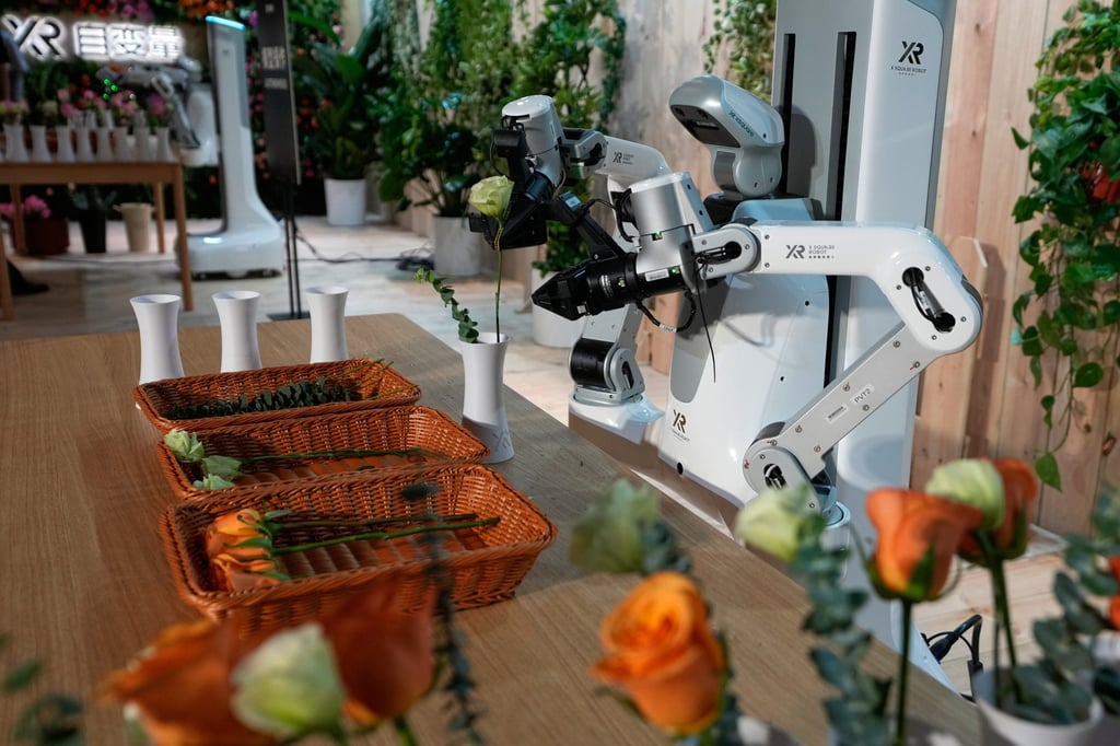 An XR robot places flowers into vases during a demonstration following X Square Robot’s introduction of the model, which can perform household tasks, in Beijing on April 21. Photo: AP An XR robot places flowers into vases during a demonstration following X Square Robot’s introduction of the model, which can perform household tasks, in Beijing on April 21. Photo: AP