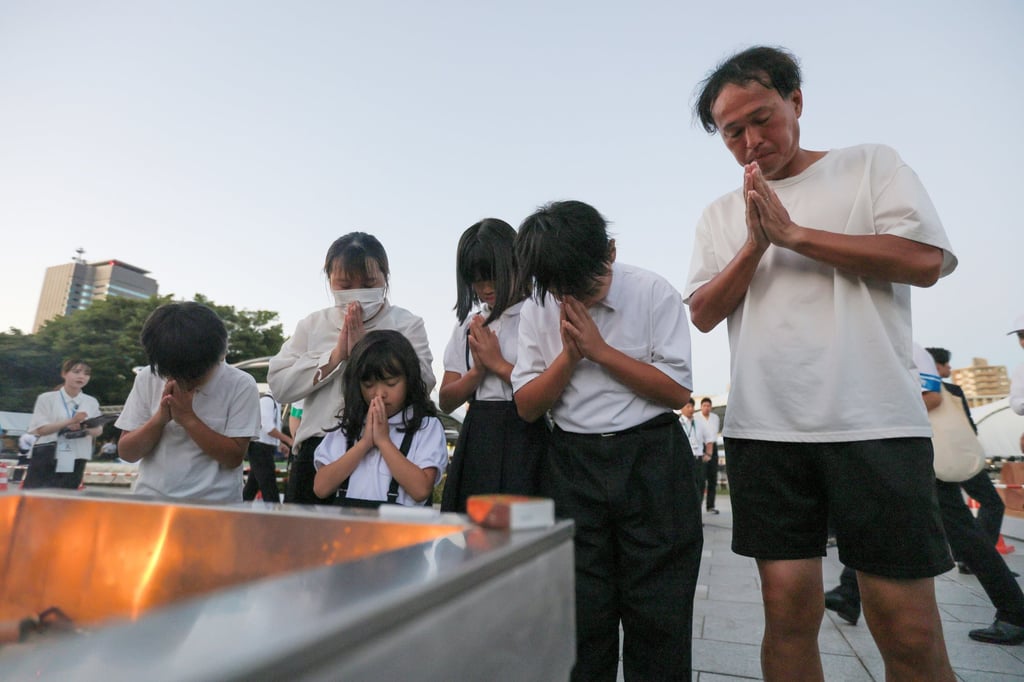 People offer prayers for the victims ahead of the Peace Memorial Ceremony on the 81st anniversary of the atomic bombing of Hiroshima at Peace Memorial Park in Hiroshima. Photo: EPA/JIJI Press People offer prayers for the victims ahead of the Peace Memorial Ceremony on the 81st anniversary of the atomic bombing of Hiroshima at Peace Memorial Park in Hiroshima. Photo: EPA/JIJI Press