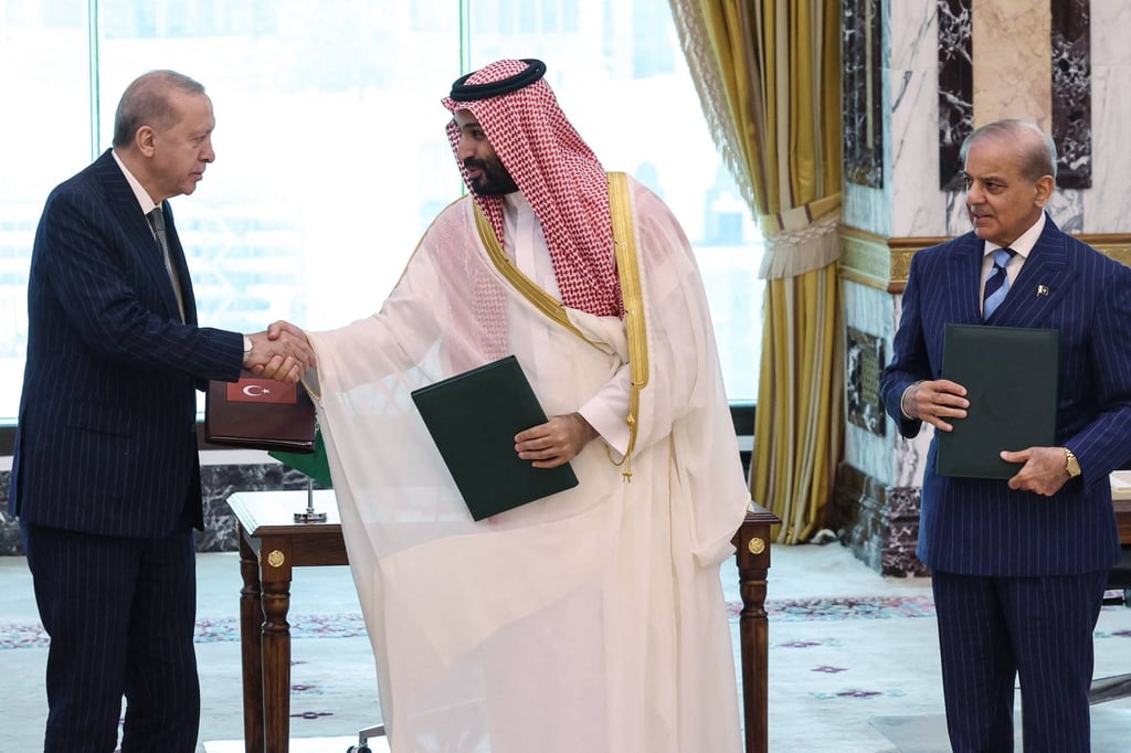 (From left) Turkey’s President Recep Tayyip Erdogan shakes hands with Saudi Arabia’s Crown Prince Mohammed bin Salman as Pakistan’s Prime Minister Shehbaz Sharif looks on, after signing a joint defence agreement in Mecca. Photo: AFP/Turkish Presidency Press Office