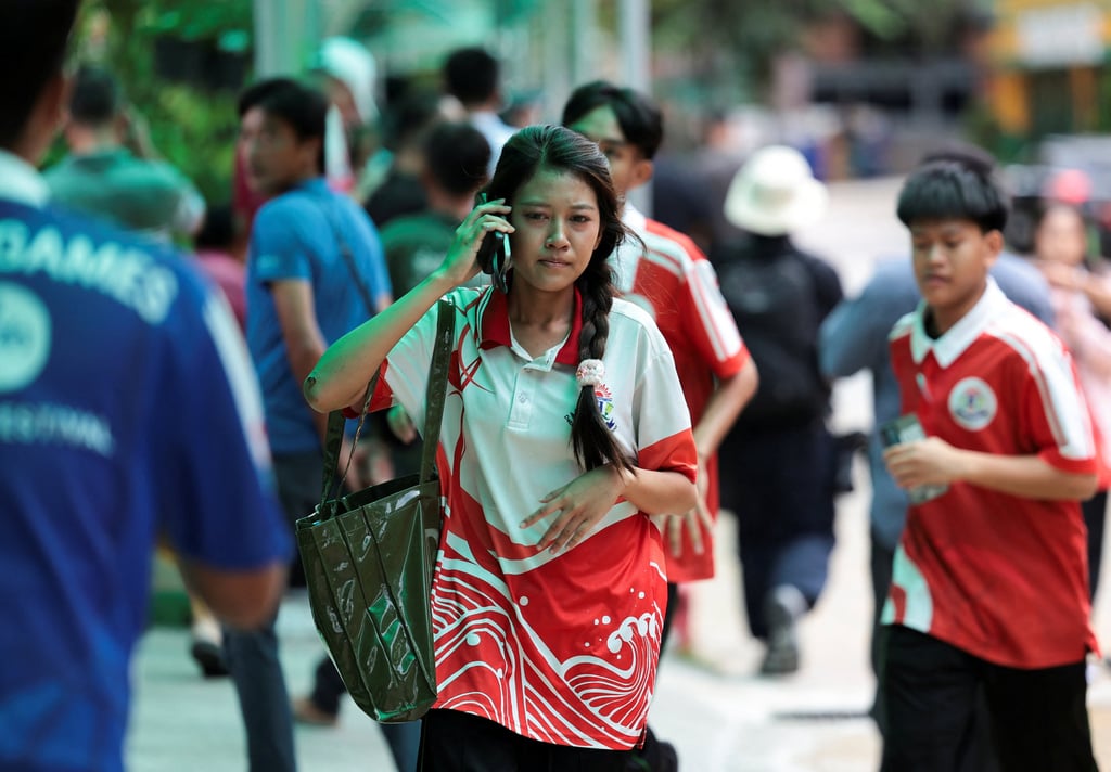 A student uses her mobile phone while walking at Debsirin Nonthaburi School on Friday. Photo: Reuters A student uses her mobile phone while walking at Debsirin Nonthaburi School on Friday. Photo: Reuters