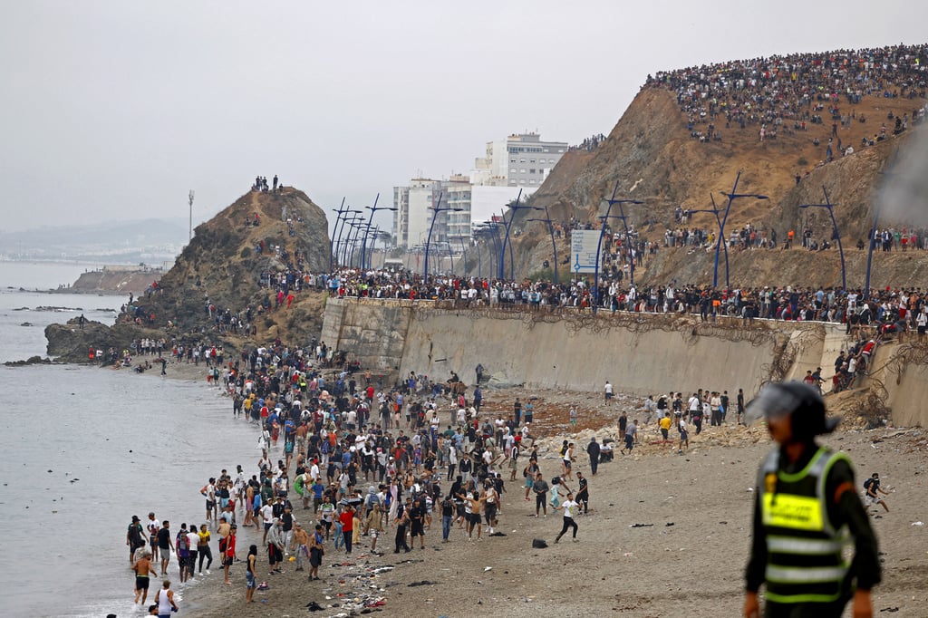 People gather on the Morocco-Spain border on July 31, as thousands of migrants crossed from Morocco into Spain’s north African Ceuta enclave. Photo: via AFP