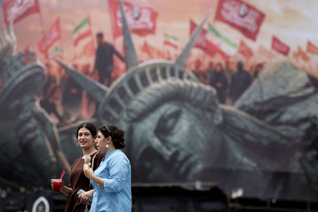 People walk past an anti-US hoarding in Tehran, Iran, on Monday. Photo: WANA via Reuters