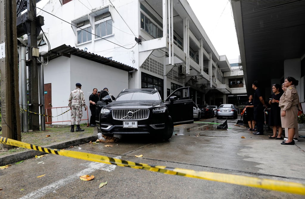 Officials from a government office stand near the scene of a fatal shooting in Nonthaburi province, Thailand, on Monday. Photo: EPA Officials from a government office stand near the scene of a fatal shooting in Nonthaburi province, Thailand, on Monday. Photo: EPA