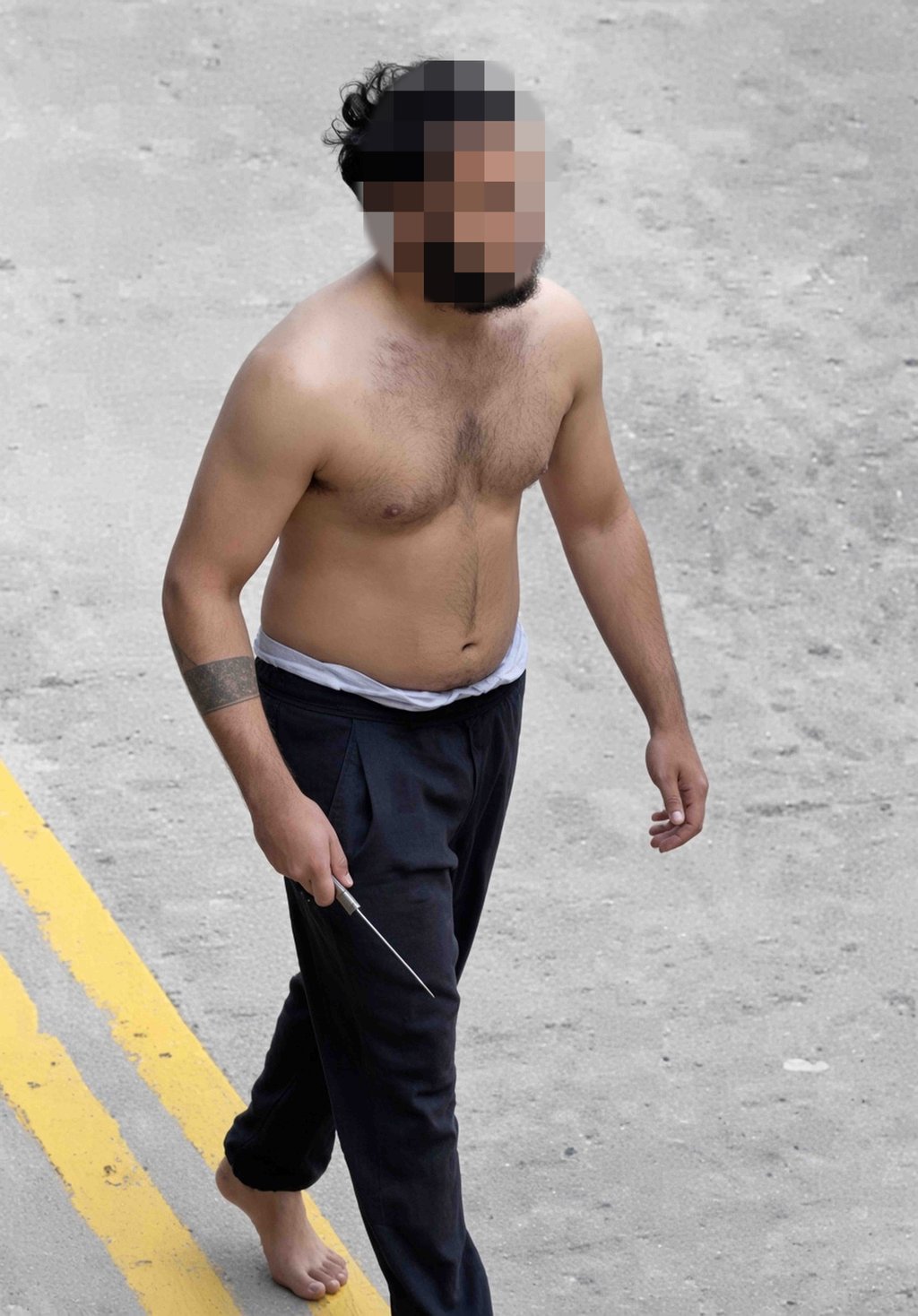 The online clips shows the knife-wielding assailant walking around barefoot and topless. Photo: Handout