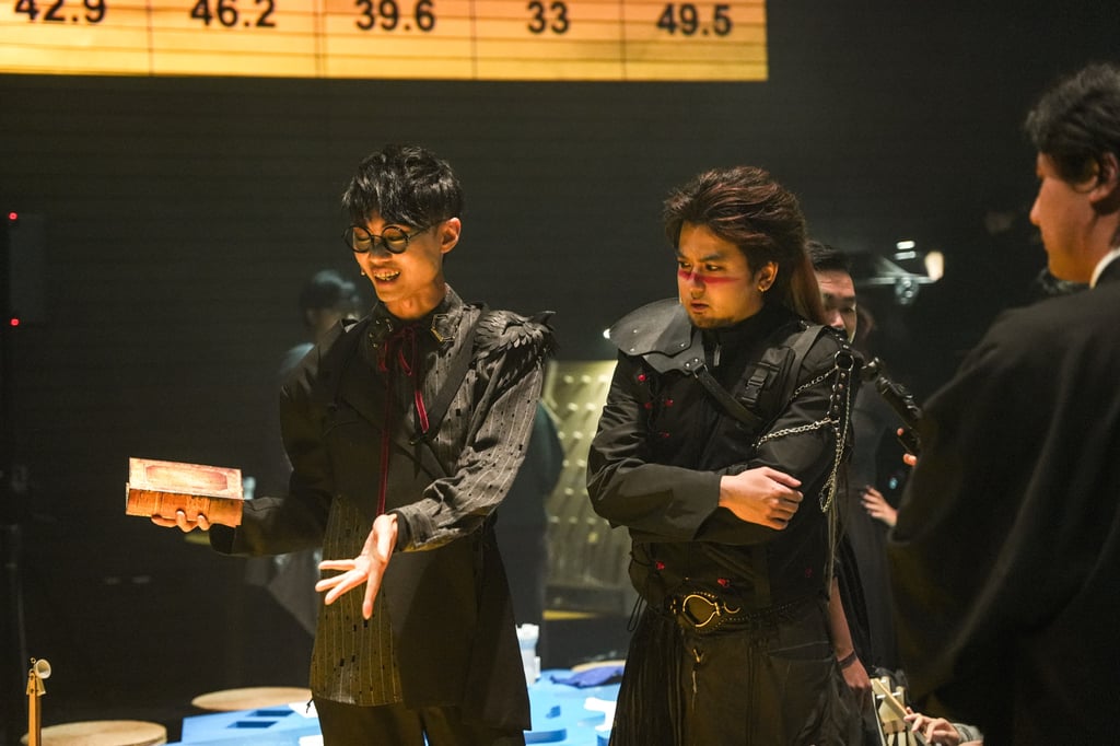 Jing Wong (left) performs during a production of When the World is Your Enemy. Photo: WestK