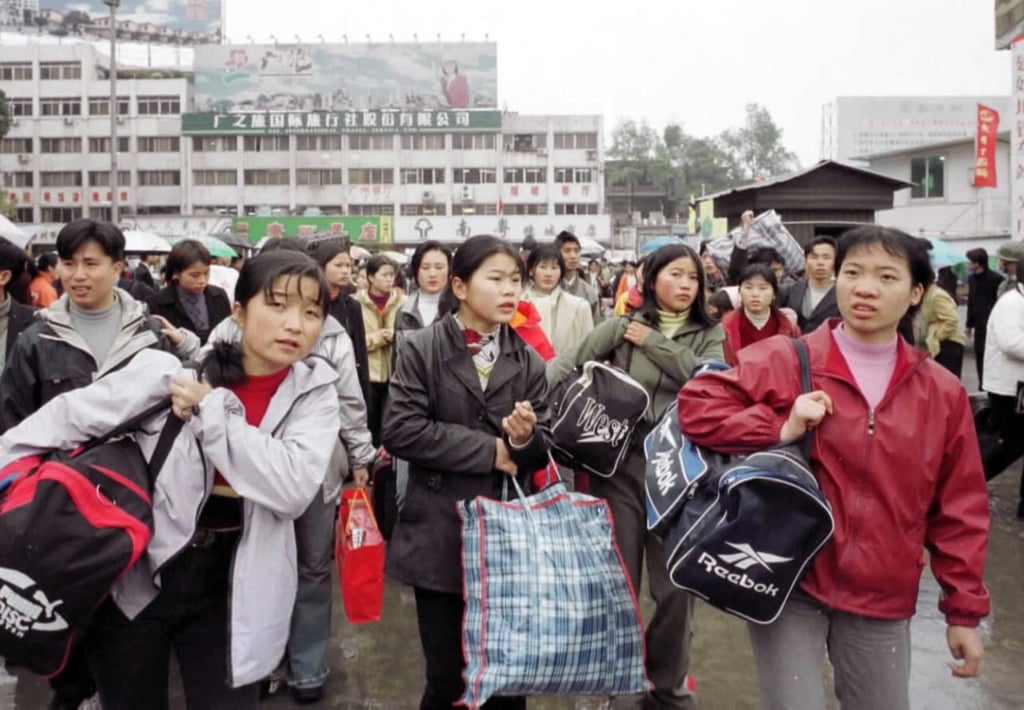 Migrant workers returning from Spring Festival leave emerge from a railway station in Guangzhou in 2001. Photo: Xinhua Migrant workers returning from Spring Festival leave emerge from a railway station in Guangzhou in 2001. Photo: Xinhua