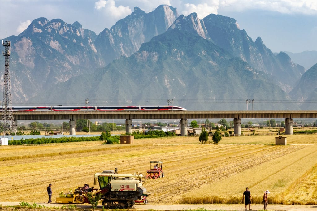 A high-speed train passes through golden wheat fields at the foot of Mount Hua, in Shaanxi province, in June. Photo: Getty Images A high-speed train passes through golden wheat fields at the foot of Mount Hua, in Shaanxi province, in June. Photo: Getty Images