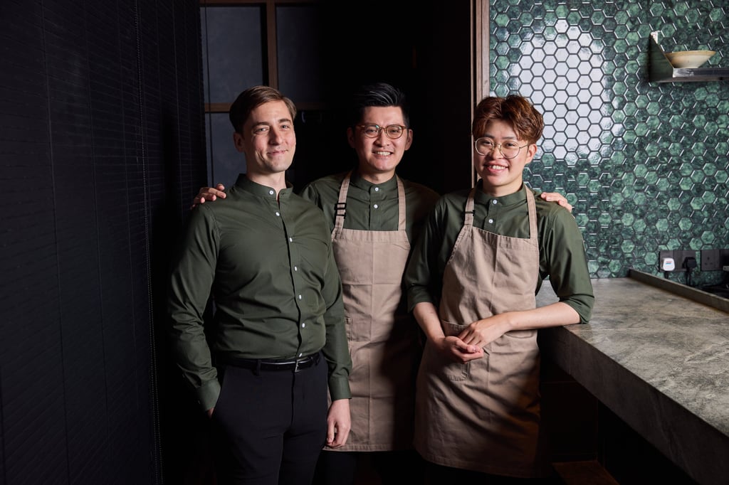 Chef Tony Mok (centre) leads his team at Path with a pre-service singing ritual. Photo: Handout