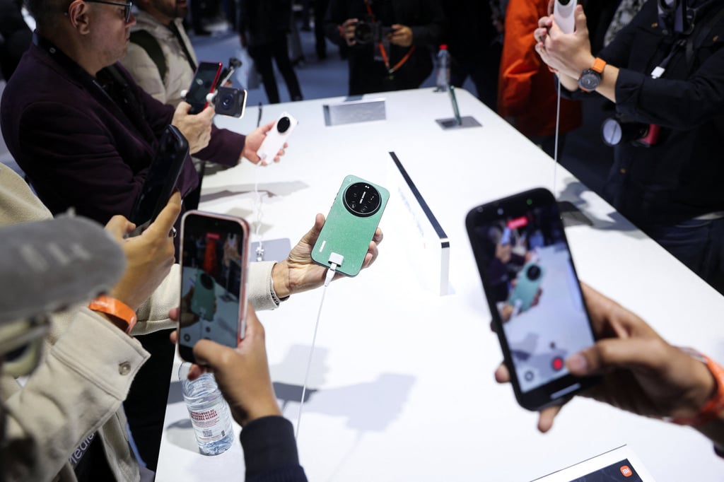 People test the latest Xiaomi smartphone models ahead of the Mobile World Congress in Barcelona, Spain. Photo: Reuters