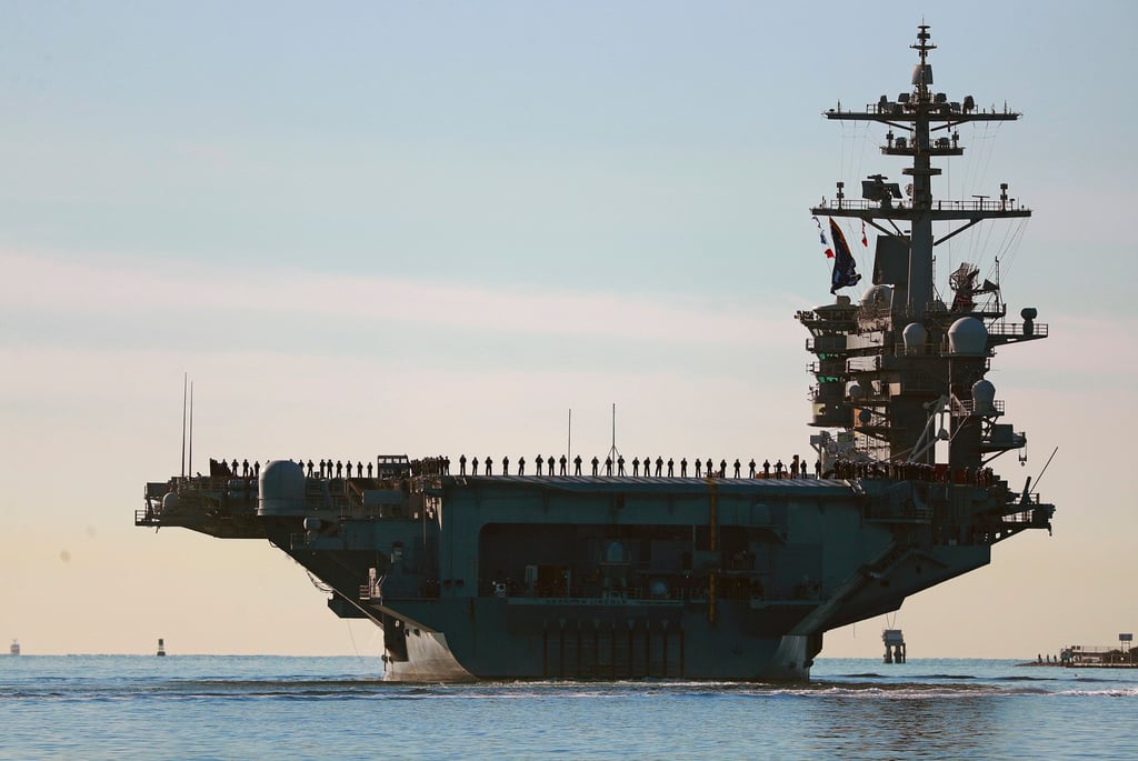 Sailors and Marines line the deck of the USS Abraham Lincoln as it deploys from San Diego in January 2021. Photo: The San Diego Union-Tribune via AP