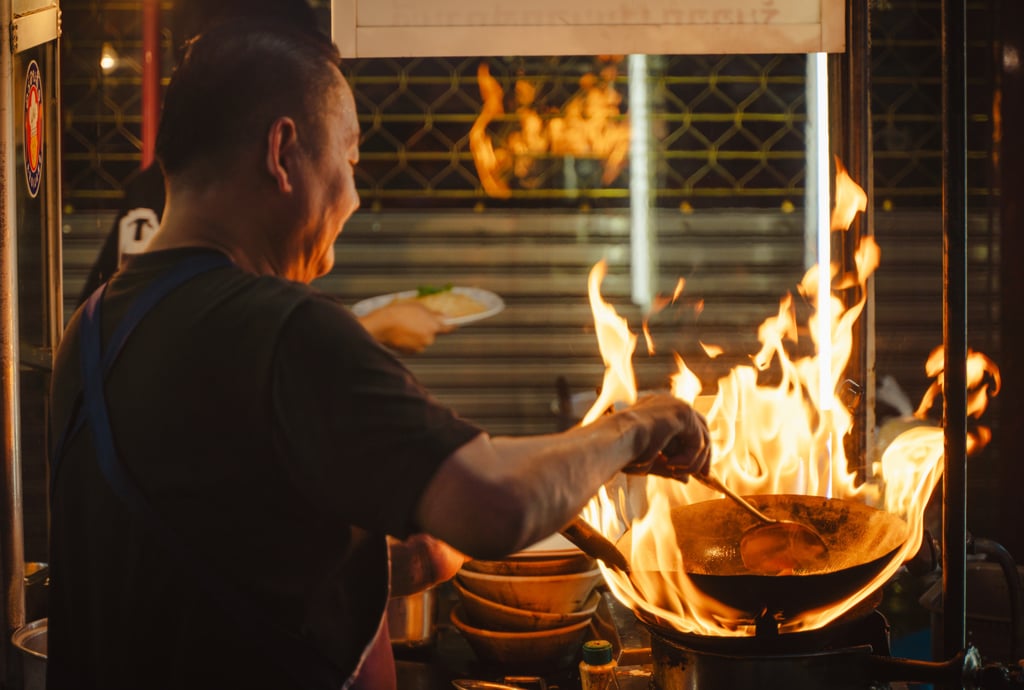 A street food vendor fires up a wok in Bangkok’s Chinatown last year. Photo: Alexander Mak A street food vendor fires up a wok in Bangkok’s Chinatown last year. Photo: Alexander Mak