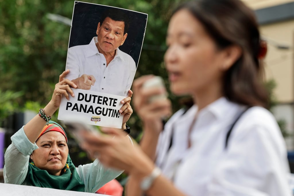A protester holds an image of former Philippine president Rodrigo Duterte with a message reading “Hold Duterte Accountable!”, during a rally in Quezon City in March. Photo: EPA