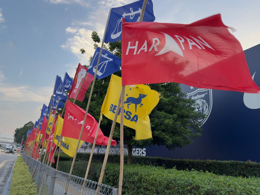 Pakatan Harapan, Barisan Nasional and Bersama flags line a road in Johor Bahru, Malaysia. Photo: Iman Muttaqin Yusof