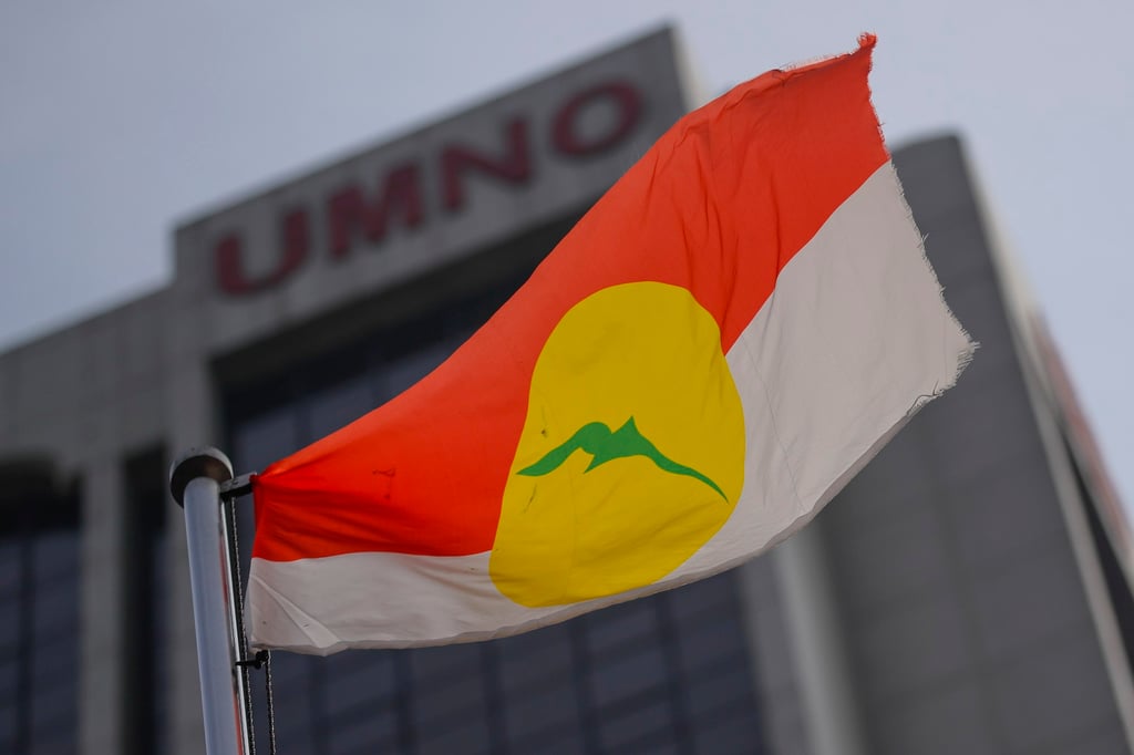 A flag of the United Malays National Organisation waves outside its headquarters in Kuala Lumpur. Photo: EPA-EFE A flag of the United Malays National Organisation waves outside its headquarters in Kuala Lumpur. Photo: EPA-EFE