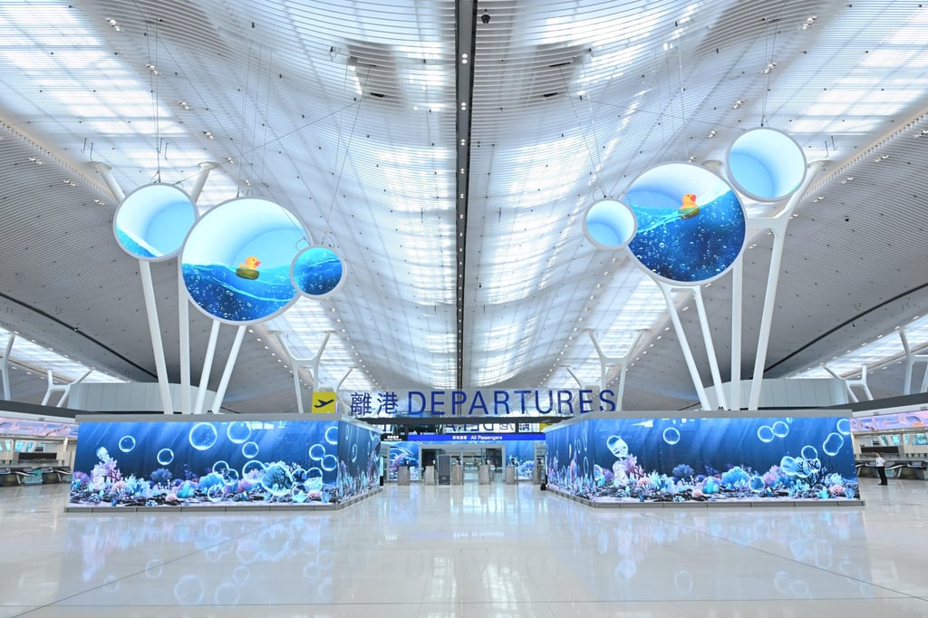 The departure hall at Hong Kong International Airport’s newly revamped Terminal 2 features large LED screens with ocean-themed displays. Photo: Airport Authority Hong Kong The departure hall at Hong Kong International Airport’s newly revamped Terminal 2 features large LED screens with ocean-themed displays. Photo: Airport Authority Hong Kong