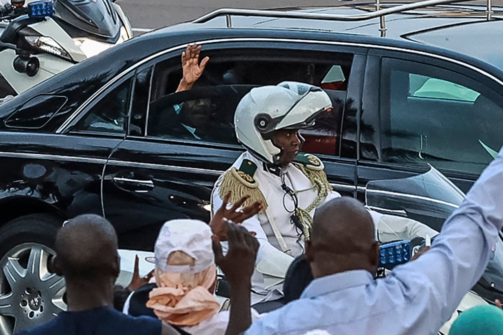 President of Cameroon Paul Biya’s motorcade is greeted by supporters as it passes through Yaounde on Thursday. Photo: AFP