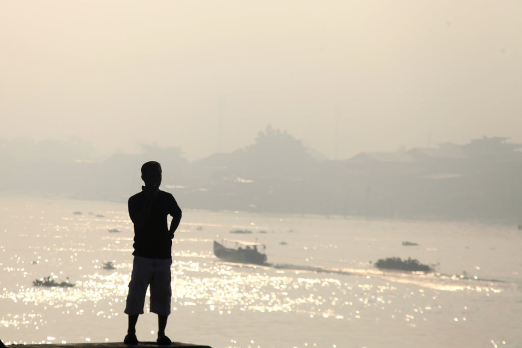 A man observes the haze from wildfires that blankets Musi River in Palembang, South Sumatra on Sunday. Photo: AP A man observes the haze from wildfires that blankets Musi River in Palembang, South Sumatra on Sunday. Photo: AP