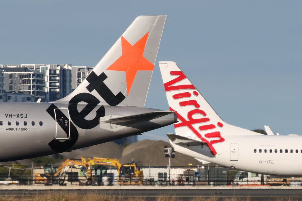 Jetstar and Virgin Australia aircraft on a runway at Sydney Airport in Australia on Friday. Photo: Reuters