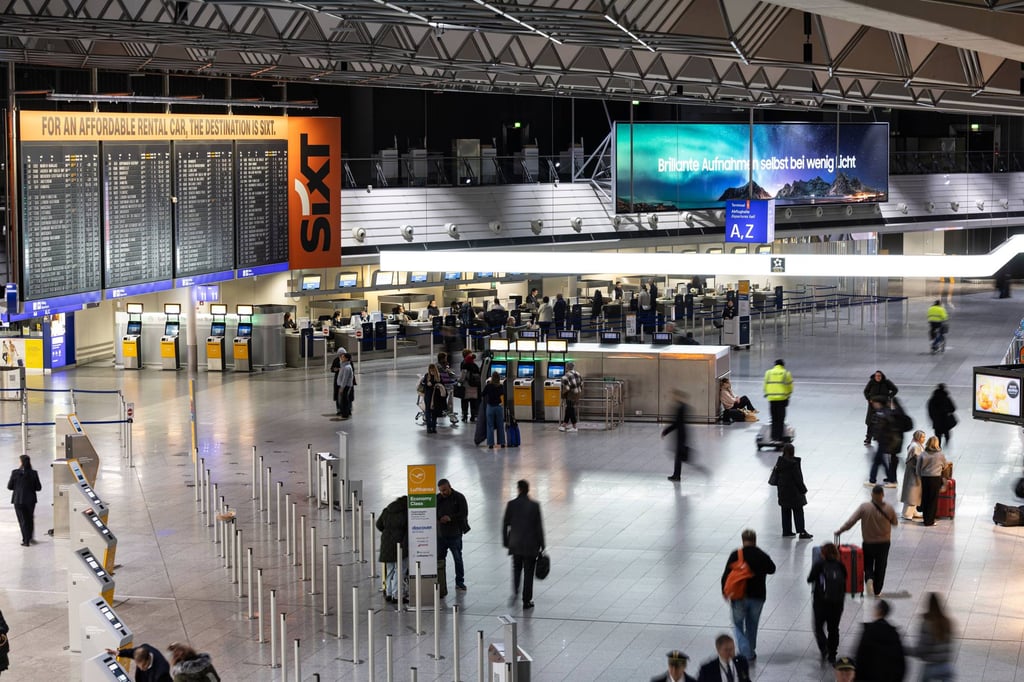 People walk through the departure hall at Frankfurt Airport in February. Photo: dpa