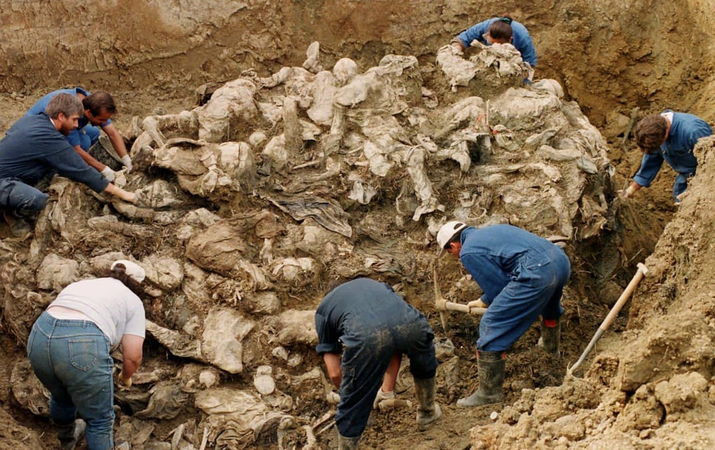 Investigators clearing away soil and debris from a tangle of dozens of bodies of Srebrenica massacre victims buried in a mass grave near the village of Pilica, Bosnia and Herzegovina, in 1996. Photo: AP