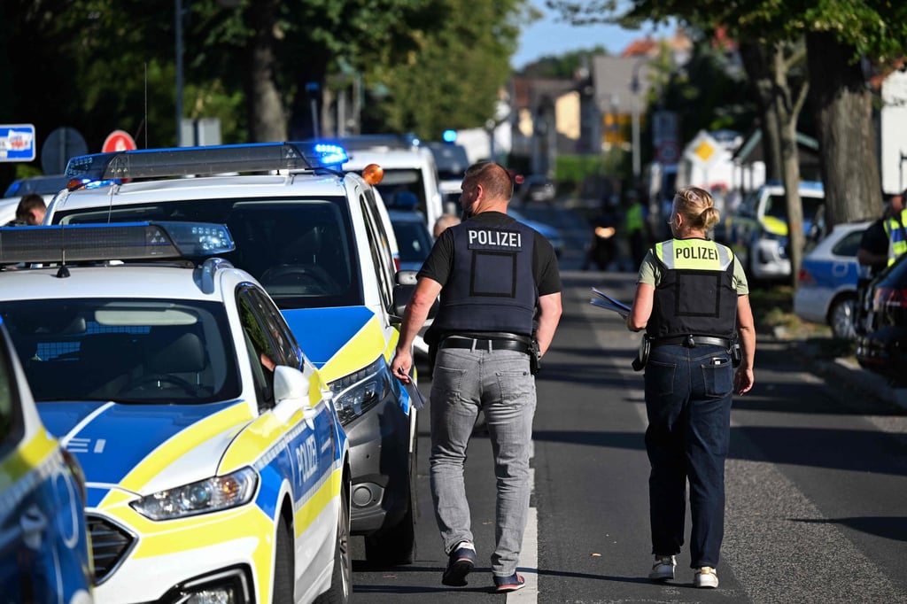 Police officers walk near the private Docemus school on Thursday, where two people were killed. Photo: AFP Police officers walk near the private Docemus school on Thursday, where two people were killed. Photo: AFP