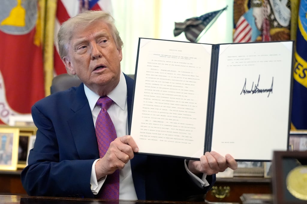US President Donald Trump holds up a signed executive order in the Oval Office on Thursday. Photo: AP