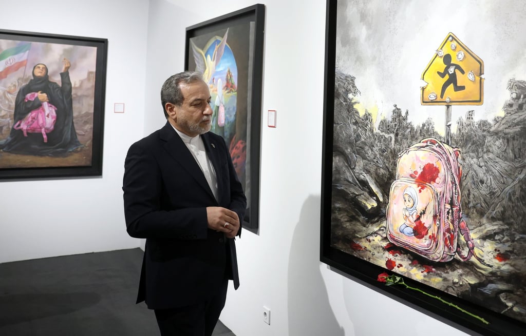 Iranian foreign minister Abbas Araghchi visits the exhibition of artworks of Minab School by contemporary painters in Tehran on Friday. Photo: EPA