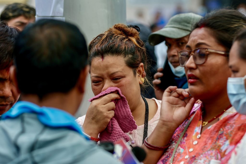 Anxious relatives wait for information at Tribhuvan University Teaching Hospital in Kathmandu on Friday. Photo: EPA