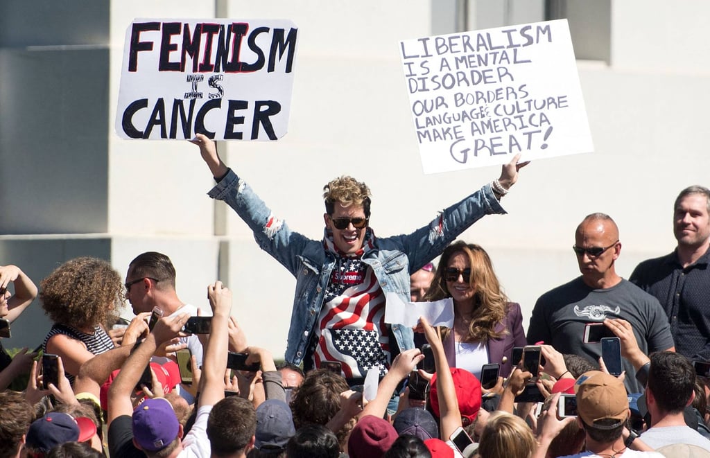British right-wing commentator Milo Yiannopoulos holds up signs to a crowd of supporters on the University of California, Berkeley campus in September 2017. Photo: AFP