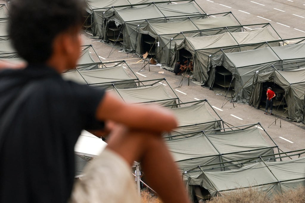 A migrant overlooks a shelter set up on August 21 after police cleared a makeshift beach camp in Spain’s North African enclave of Ceuta following a mass crossing from Morocco. Photo: Reuters A migrant overlooks a shelter set up on August 21 after police cleared a makeshift beach camp in Spain’s North African enclave of Ceuta following a mass crossing from Morocco. Photo: Reuters