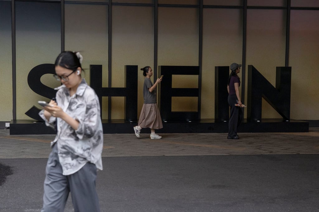 People walk past the Shein logo in Guangzhou on August 26. Photo: EPA