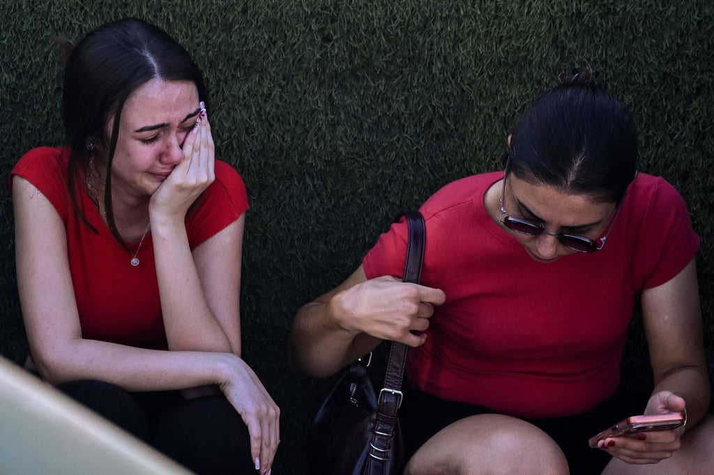 People await news of their loved ones outside the port in Kyrenia, in the self-proclaimed Turkish Republic of northern Cyprus (TRNC), recognised only by Turkey, on Sunday after a ferry capsized off the coast. Photo: AFP