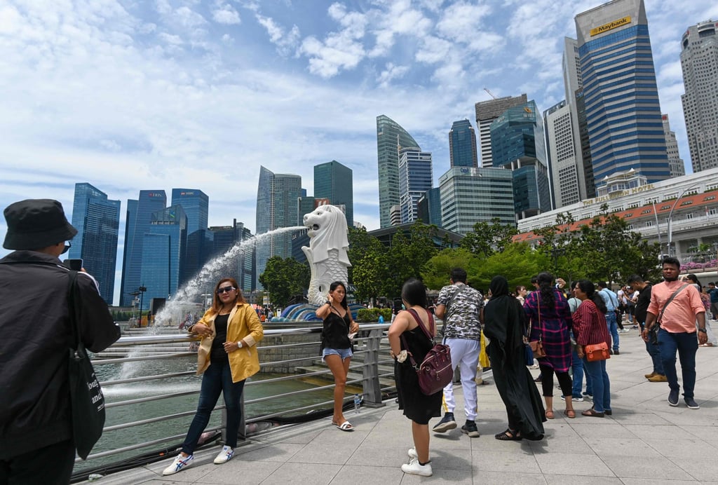 People gather next to the Merlion statue at the Marina Bay waterfront in Singapore. Photo: AFP People gather next to the Merlion statue at the Marina Bay waterfront in Singapore. Photo: AFP
