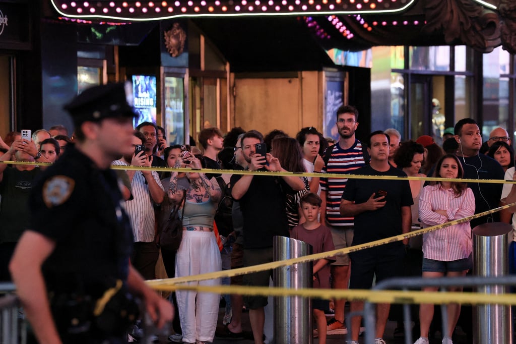 People gather as NYPD Commissioner Jessica Tisch and New York City Mayor Zohran Mamdani hold a press conference at the crime scene in Times Square. Photo: Reuters