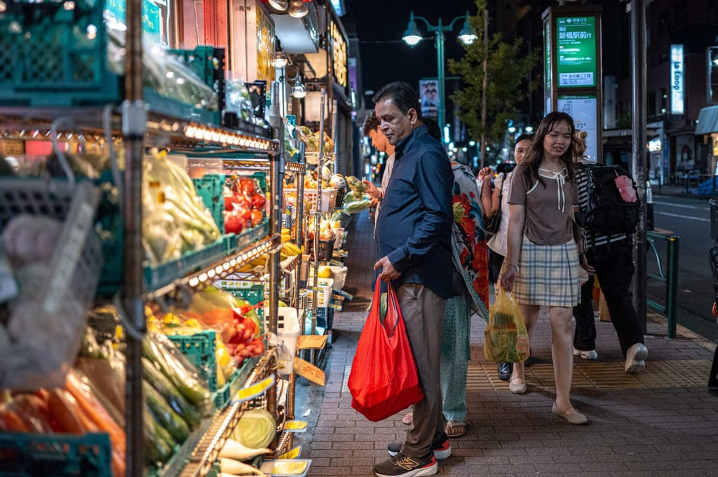 A man shops at a grocery store in Tokyo’s Okubo district on August 23. Photo: AFP A man shops at a grocery store in Tokyo’s Okubo district on August 23. Photo: AFP