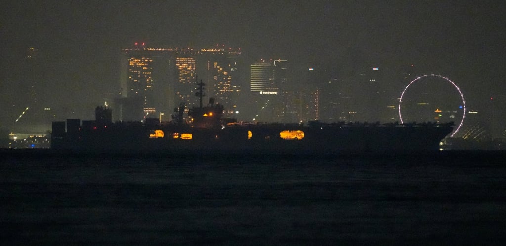 The USS Abraham Lincoln sails past Singapore as seen from Batam, Indonesia, on Sunday. Photo: AP The USS Abraham Lincoln sails past Singapore as seen from Batam, Indonesia, on Sunday. Photo: AP