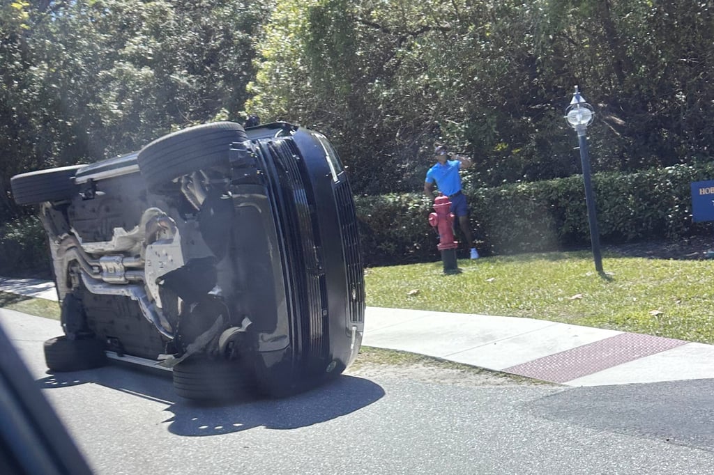 Tiger Woods stands by his overturned vehicle in Jupiter Island, Florida, in March. Photo: AP Tiger Woods stands by his overturned vehicle in Jupiter Island, Florida, in March. Photo: AP
